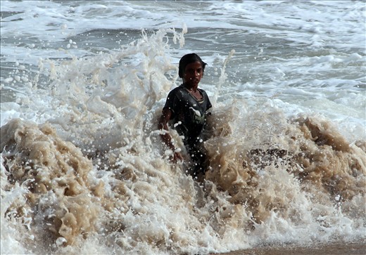 A child enjoying the enigmatic sea.