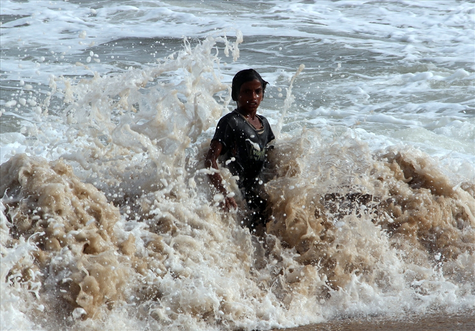 A child enjoying the enigmatic sea.