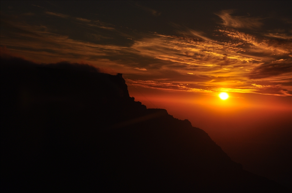 This... this was one of the more beautiful moments in my life.  When the moon's full in Cape Town, a lot of people like to hike Lion's Head and watch the sun set over the Atlantic, and the full moon rise opposite.  I decided to hike Devil's Peak, which is 4 times as long, and I was the only one up there!  A mountaintop all to myself.  I was up there for hours and hours, watching the clouds roll over me, and when the sun was setting the clouds around me were glowing orange, as if I were alive in a fire.  I was imagining all of the people in the city below me rushing aimlessly from point A to point B, wondering why so many can't enjoy true beauty.  This was my second last night in CT, and the end of my adventure there... until next time.