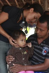 Located in Dili, the capital of Timor-Leste, Bairo Pite Clinic is focused on 'community health care for the poorest of the poor in Timor-Leste', and has operated since 1999. This image was captured in a small village about four hours outside of Dili during one of the irregular mobile clinics. The young Australian medical student tended to 'walk-ins' that came to the thatched roofed structure beside the road. Clients ranged from TB patients, to children with infected insect bites. : by sylviafrain, Views[1078]