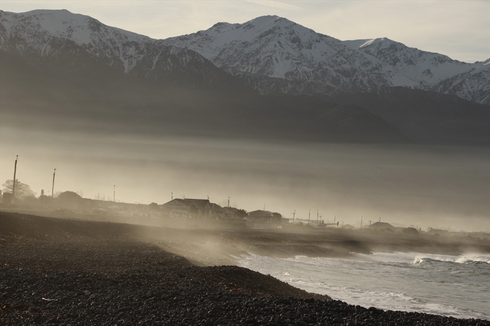 As the traveller and the birds have left to settle for the night, the wooden houses stand still, lifeless amongst the misty haze. The waves continue to crash against the shore yet the beach becomes cold without life. – Kiakoura, New Zealand