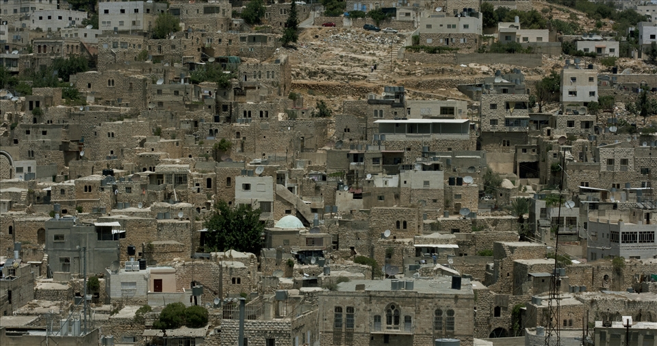 Through a process of rapid settlement expansion, and the very tactical nature in which this is done, Palestinian families are being forced into increasingly smaller spaces for habitation. The West Bank city of Hebron is a perfect example, with many areas of the cities looking more reminiscent of favela's than city dwellings. The hill pictured in this photograph was bombed extensively in the 2000 Intifada. 