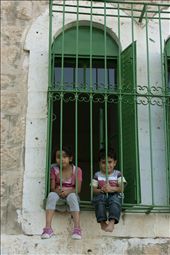 Two children welcomed our group of international visiters to their home in Hebron. Their home had become such a frequent target for Israeli aggression that all of the windows have steel bars to protect the inhabitants, and the children are not allowed to leave their home for more than 10 minutes at a time. Even with these horrendous circumstances for a child to be reared, they still have the curiosity and childishness to wave and smile to new people. : by takenbytom, Views[343]