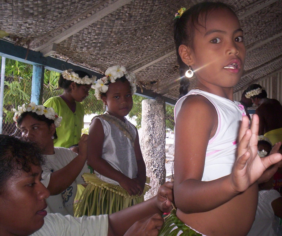 Aunties prepare a young dancer for her traditional Mwaie