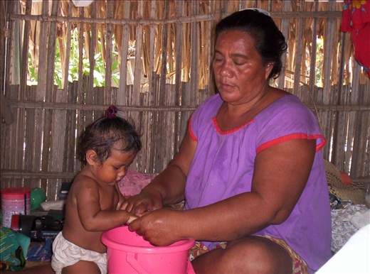Grandma washing baby's hands