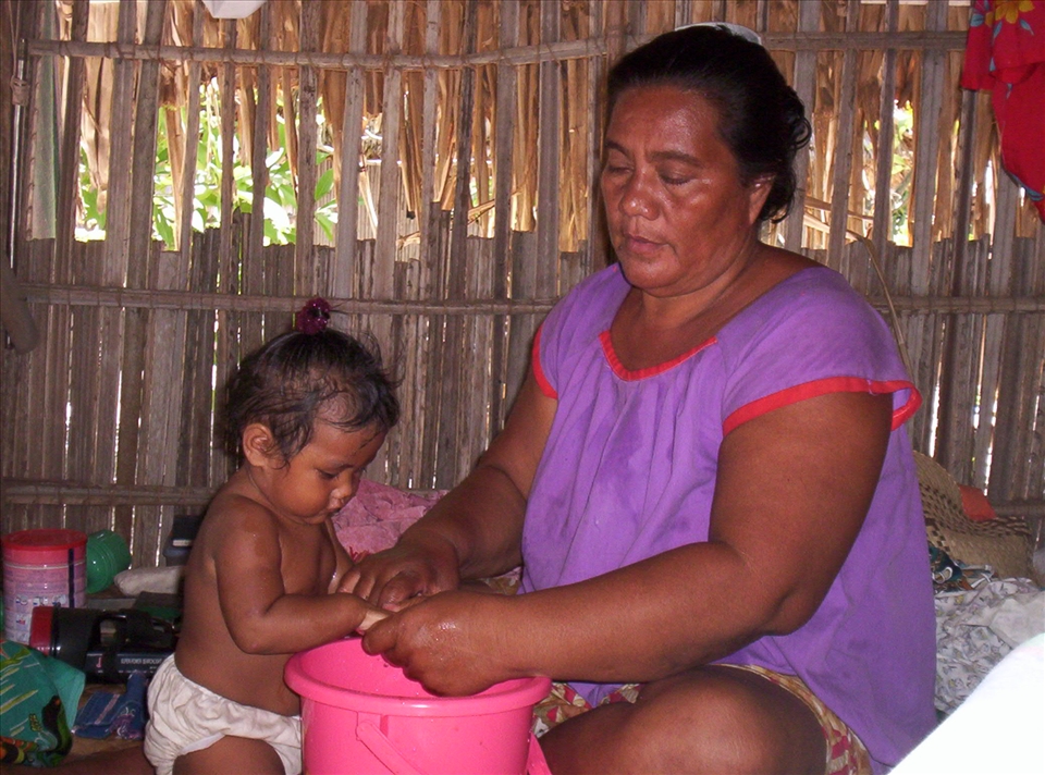 Grandma washing baby's hands