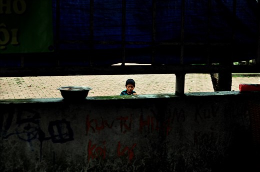 He is an orphan I met at a village right under Long Bien Bridge. He had no relatives left. His meal usually comes from the waste food from street vendors.