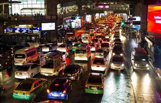 The busy bustling streets of Bangkok with the bright lights of cars below me.