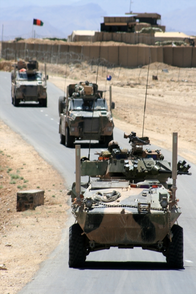 Australian Forces on a vehicle patrol. The ASLAV in the front is the main firepower and wards off any potential attackers. In the background is a patrol base once occupied by Australian forces, but now only home to Afghan National Army (ANA)