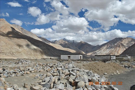 Shadows of the clouds fall on the mountains,as if giving company to the houses