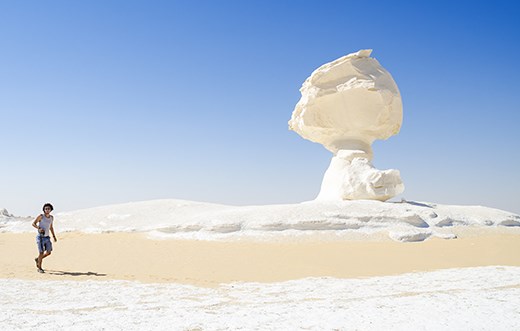 Hiking in white desert to see the strange natural rocks