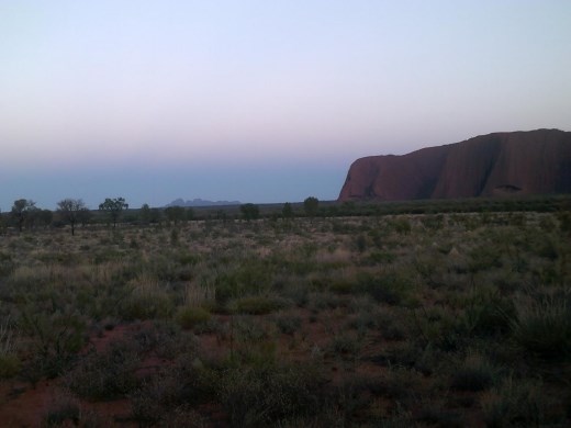 In the distance you can see Kata tjuta, a group of similar, but smaller, rock formations like Uluru.