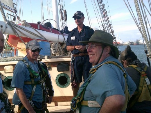 In the center is Stan, after he helped Kent get into his harness for the climb up the mast!