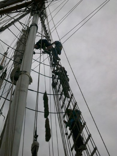 ... THE TOP! Phil makes sure Kent is securely fastened to the rope for the descent. (Meanwhile, Anna is getting a serious neck ache trying to point the camera straight up!)