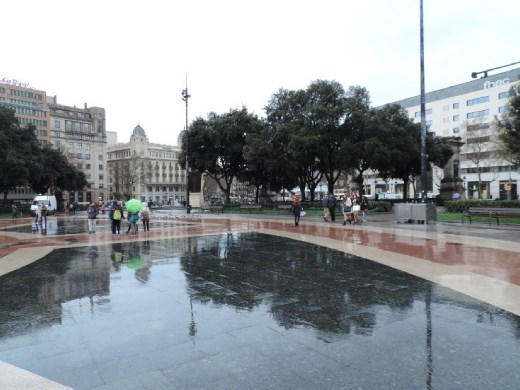 The wet day created a mirror image in the plaza tiles.