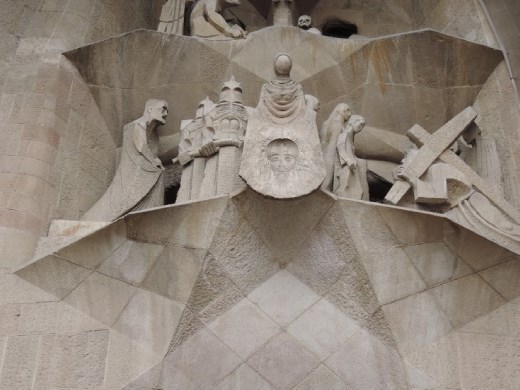 The kneeling figure on the left has Gaudi's face.