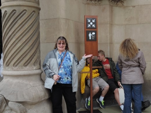 Anna mimics the sign as we wait for our tour guide. This was the face of the lady at the information desk as she told us where to wait for our tour.
