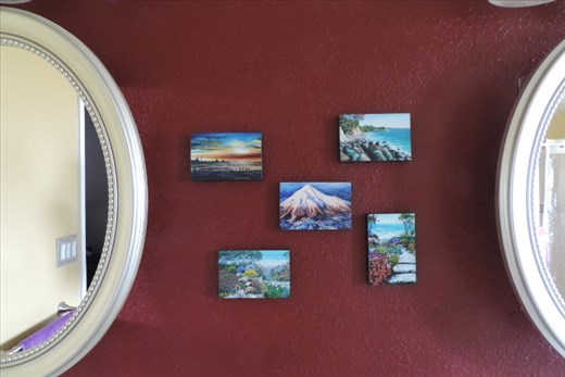 Our Master Bathroom has the same color accent wall as the Master Bedroom. We tucked these small prints (outdoor scenes painted on wood) in the small space between our mirrors. The prints depict the wide variety in landscape for the Taranaki region on the North Island of New Zealand.
