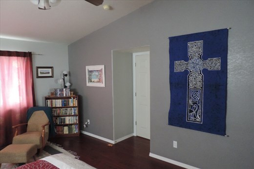The third wall of art in our Master Bedroom shows a large Celtic cross on a cotton wall hanging (purchased on the Isle of Skye, Scotland) and a beachy print from Cairns, Australia (near the Great Barrier Reef). You can just see the edge of the sitting area on the far left of this photo.