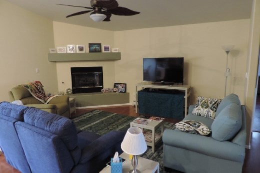 Here is our comfortable living room. We're still working on placing art of the walls, but should have something up early in 2016. After being cramped on small, low couches and chairs on our travels, it's truly a joy to lounge in our own loveseat and chairs. Come and join us!