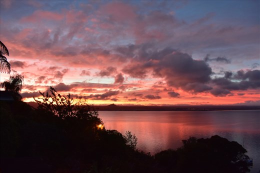 There are hints of blue sky amid the red and orange clouds.