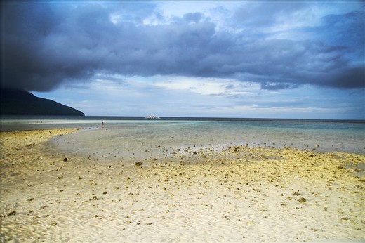 Those aren't storm clouds. The weather was just really perfect for taking photos. This was what the island showed me after leaving the boat and walking a few steps away from the crowded area. A beautiful and breathtaking scenery of overcast clouds meeting the ocean at the center. 