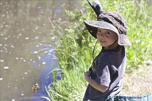 Catch of the Day. Although it's not a brown or rainbow trout, Mason is still pleased with himself and his crawdad. There's nothing more exciting than a pull on your fishing line.