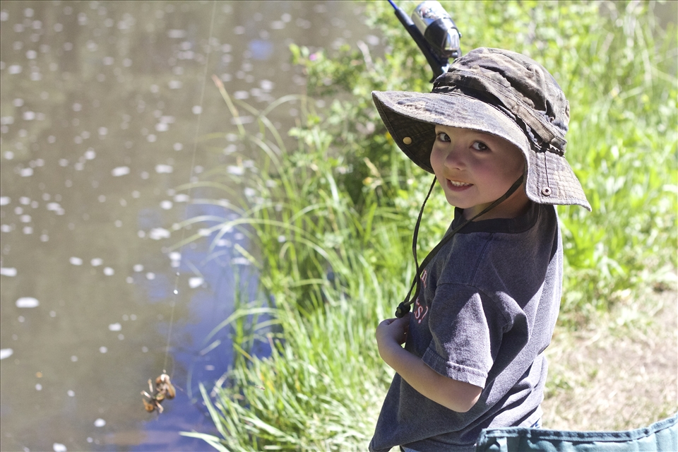 Catch of the Day. Although it's not a brown or rainbow trout, Mason is still pleased with himself and his crawdad. There's nothing more exciting than a pull on your fishing line.