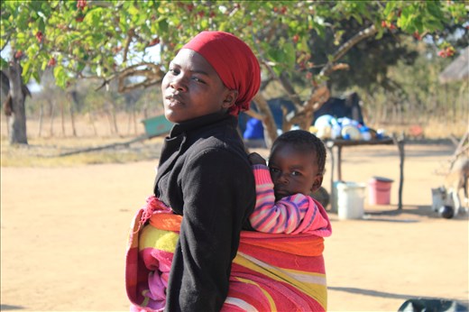 Shona is a patriarchal society and chores are divided according to gender then ranking. This is my brother’s wife Vimbai and their first child. As a daughter in law she has been up since 5am sweeping the yard and doing last night’s dishes, all the while carrying a baby on her back. This photo was taken as she was heading off to help cook breakfast for over twenty-five people. There is always a chore for her to be doing and she won’t rest until going to bed in the evening.