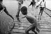 Children are everywhere. Many are sent to school during the day, others do not attend school and spend their time playing and swimming at the dock. On the warmest of days, the dock is slick with water as youngsters take turns launching themselves into the water below.: by tenzijth, Views[661]