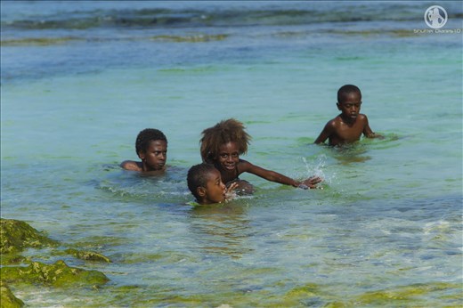 local Vanuatu children playing in lagoon