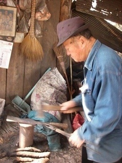 Village elder forging knives