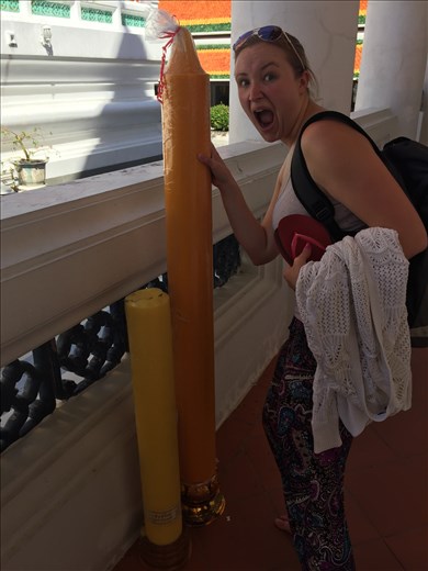 Charlotte next to a giant candle