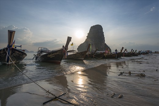 On Railay Beach in Thailand with a string of cooking boats!
