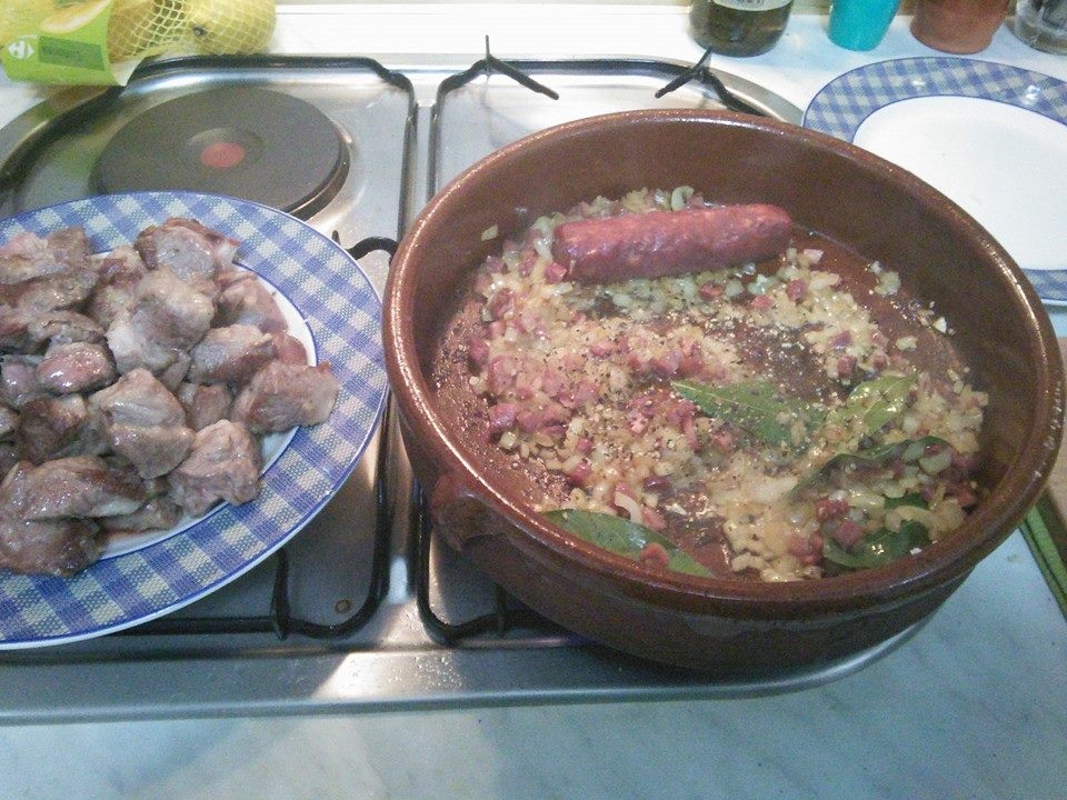 Remove the Pork, Saute the onions with jamon, bay, spices and chorizo.