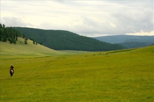 A lone rider picks his way between the rolling hills of the Steppe
