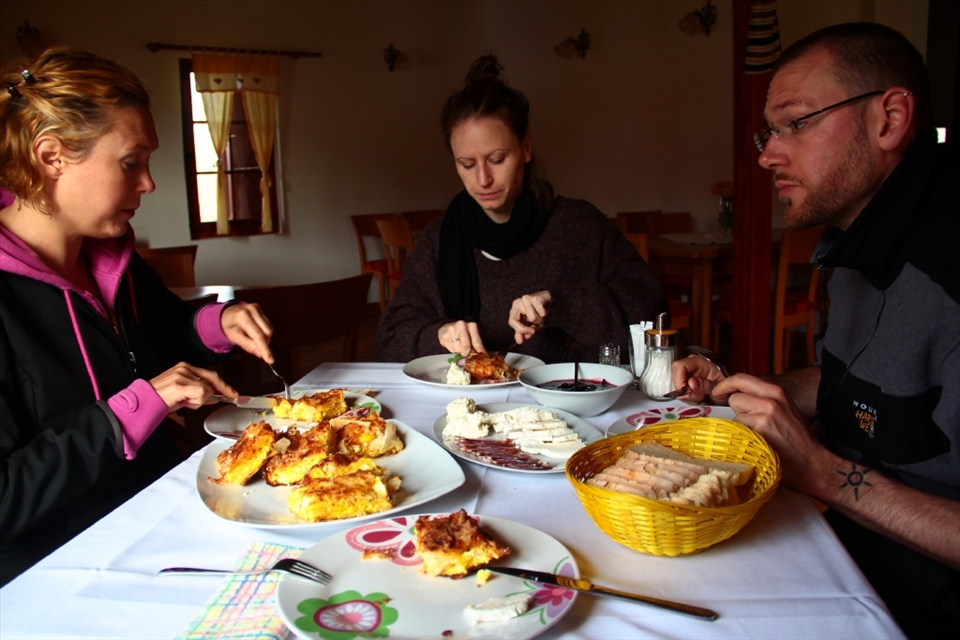 Traditional serbian village breakfast including cheese pie, dried meat and kaymak, a local dairy product
