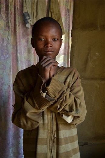 One’s hands joined.
His name is Kmeni, he is thanking me. I gave him some colors and papers because he loves to draw.