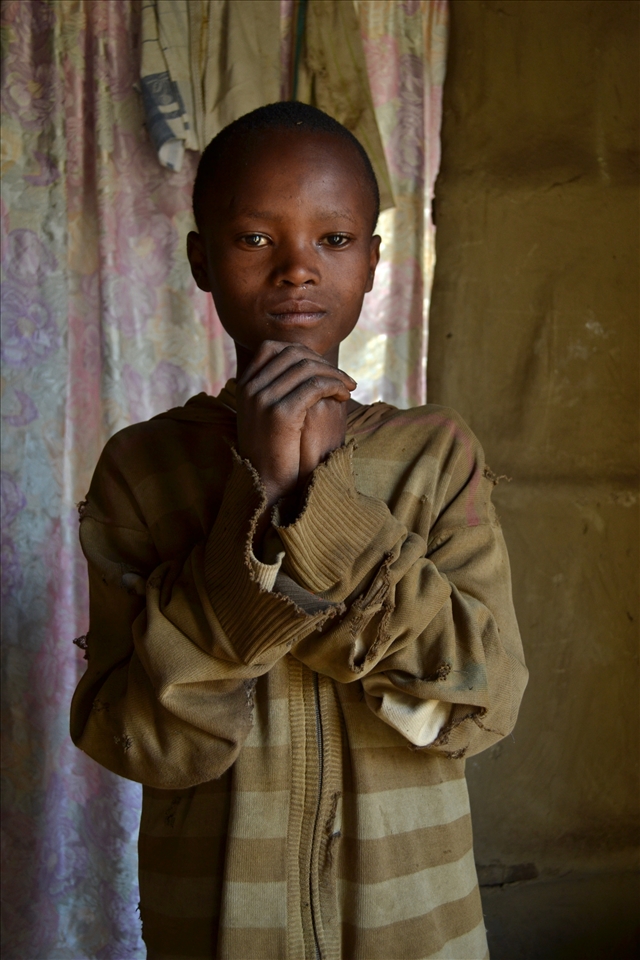 One’s hands joined.
His name is Kmeni, he is thanking me. I gave him some colors and papers because he loves to draw.