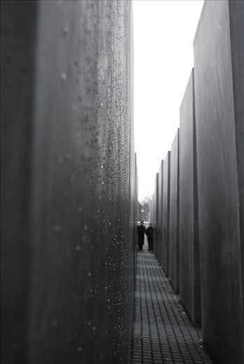 Inside the Holocaust Memorial - some rain droplets running down one of the hundreds of identical polished granite pillars rising up from the ground; a monument erected in memory of the lives lost to the genocide of Nazi Germany.