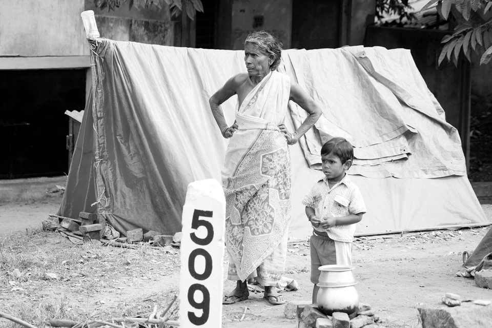 Many children in India are born into extreme poverty and experience it to the maximum. The boy and elderly woman in this picture are standing by their tents close to the railway tracks. Malnutrition, lack of education, drugs and sexual harassments are everyday problems for these children. They live in the margins of a society not fitting in and failing in life. Some of these children are abused so badly and used as child workers while some of them become anti social criminals and end up in prison. 