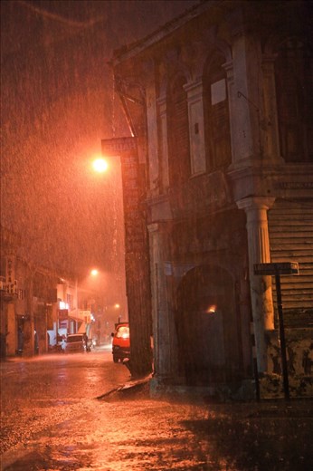 Rainy night at Mr. Soon's rented family home and workplace. His family generations have been staying here for the past 120 years. Life here however is coming to an end for Mr. Soon and his family by December 2014. With the once famous British colonial trading settlement - George Town rapidly turning into tourist town after the conferment of UNESCO title in 2008, he is not spared from merciless home eviction due to capitalism. Even being listed in the intangible heritage trade inventory, Mr. Soon today is facing the threat of not having a place to run his old trade, as the rental price tag has skyrocketed to an unrealistic figure, that poses so much threat to his already endangered trade - the bamboo and rattan weaver trade. He is contemplating to stop his old trade, not because of the lack of business volume, but basically involuntary movement (without any protection and relocation effort from UNESCO official monitoring agency) and high rental for alternative place. The gentrification of tourism has caused ripple effect of lacking of workplace for traditional trade and residence for the living heritage. Food for thought. We hope this series of documentary photos give us room to think, how could we make the photos meaningful and to help the community at large.