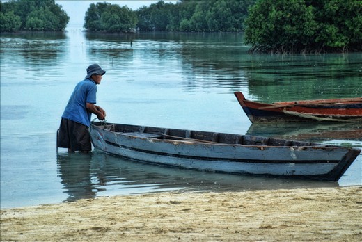 A Man and His Boat at Pari Island, Kepulauan Seribu, Jakarta, Indonesia