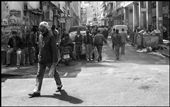 A central street of Athens has turned into crowded ghetto, where hundreds of immigrants who came to Greece for a better life, face the decline .. Somewhere a Greek flag reminds us where we are ..: by themisbadas, Views[2285]