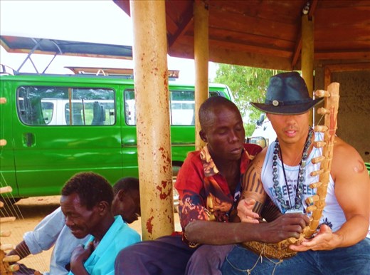 Sometimes it's good to sit [Playing the Luo harp (Nile River, Uganda)]