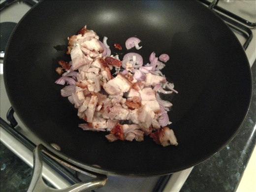 Put in the roast pork and shallots. These are the aromatics. 