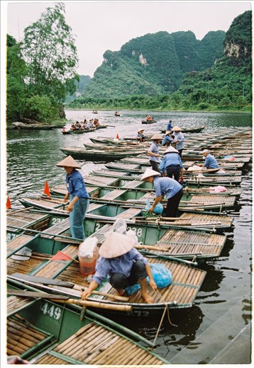 After steering the ferry back to the departure, most of the ferrywomen are ligaturing the ferries together while some of them are taking a rest after a long and tiring trip. 