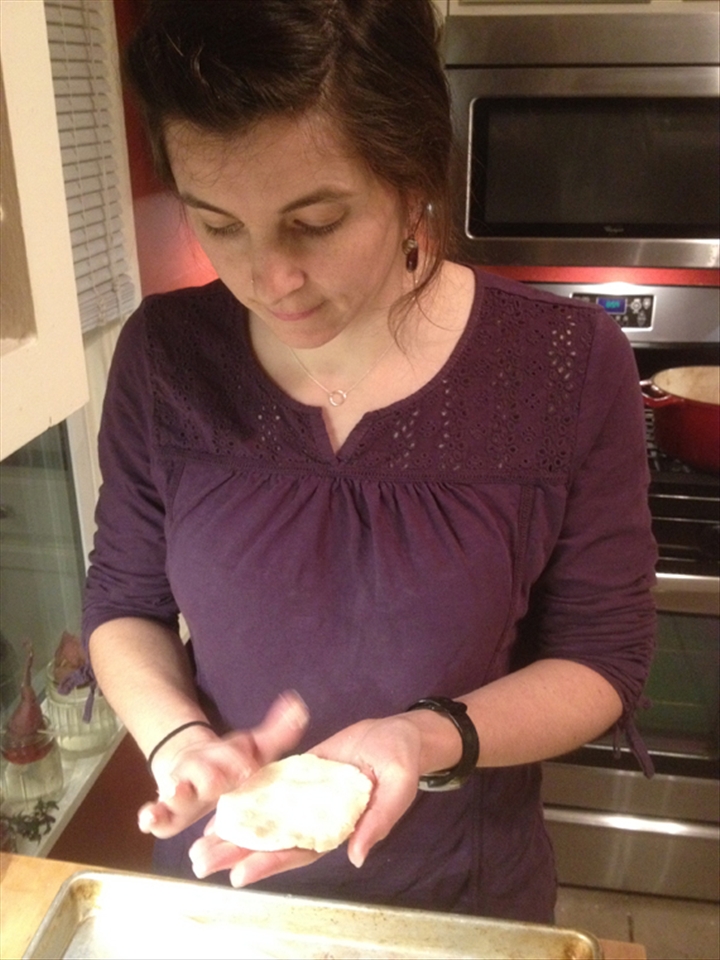 Jamie shaping the masa into disks to then fill with the sauce to make chuchitos