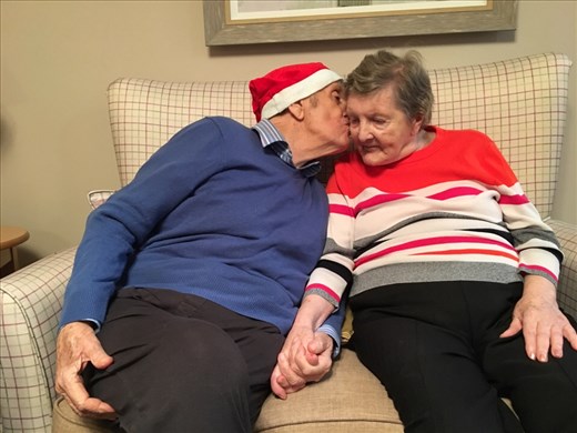 Mum and Dad sharing a Christmas kiss 