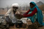 A Trader with his wife cooking dinner in the open field. In the evening you can see all over the trading field make shift 'Choolah' (cooking stove). Some traders come with their wives and few come with their friends but most of them cook their own food.: by thirdeyeview, Views[746]